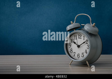 Still life with vintage alarm clock  show 10.10 o`clock on rustic blue background, Choose a focal point, copy space for write. Stock Photo